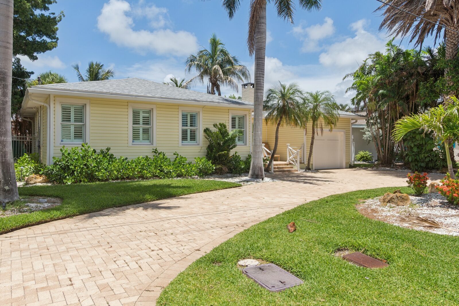 Cottage side view — driveway, garage and landscaping