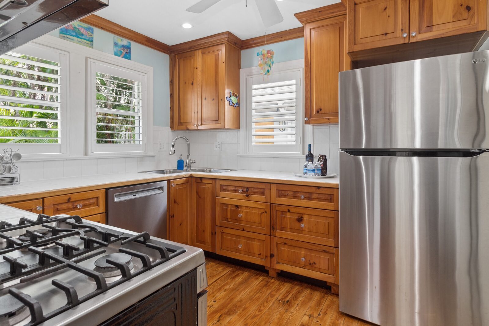Kitchen with knotty pine cabinets and gas stove