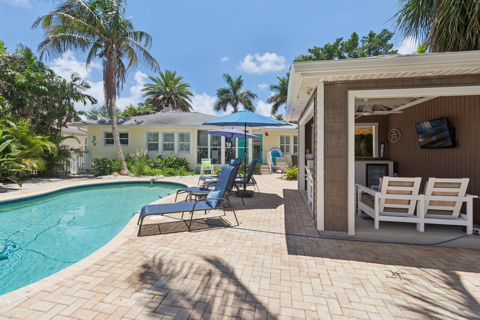 Pool with lounge chairs and pool house