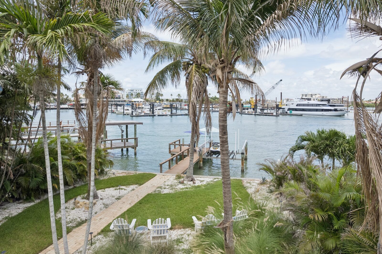 Backyard waterway view with Adirondack chairs