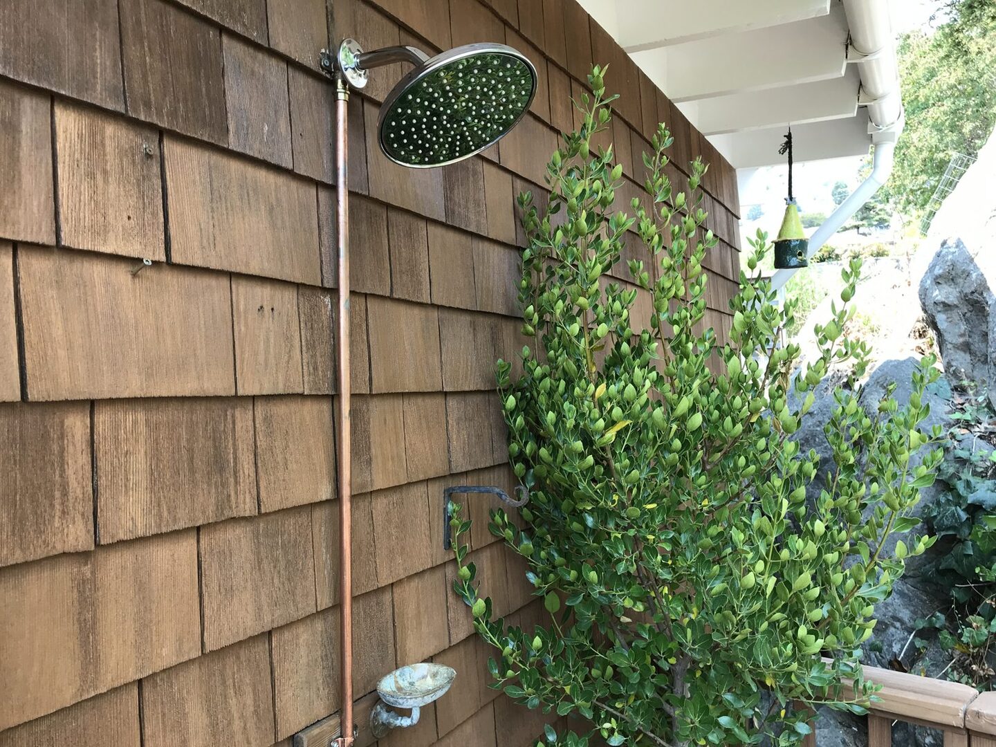 Outdoor shower nestled against the hillside