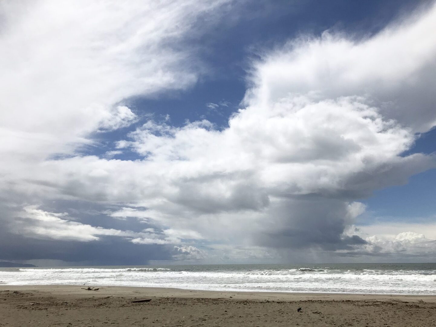 Dramatic clouds breaking over the surf