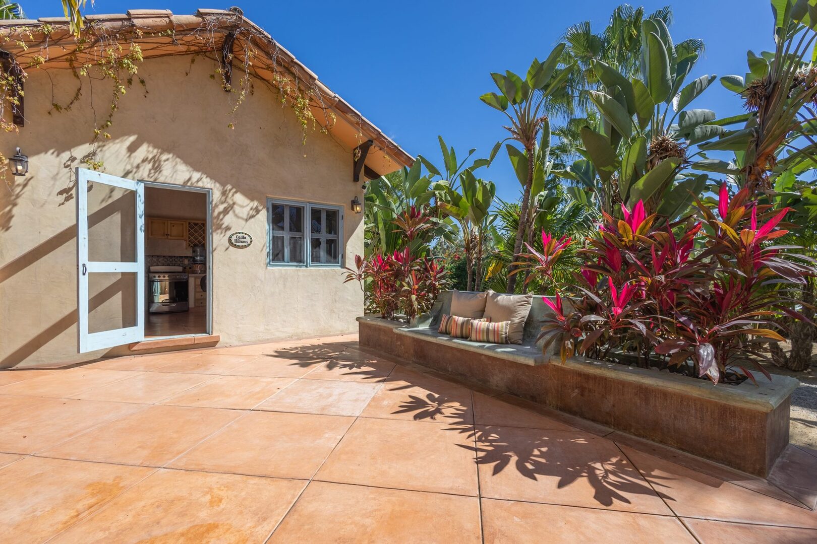 Casita Hibiscus exterior with private patio and tropical garden
