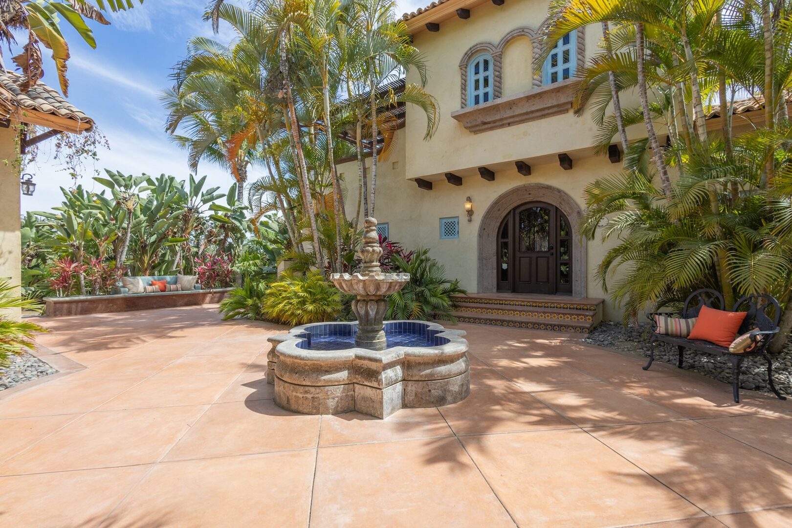 Courtyard fountain and tiled entry steps to the main house