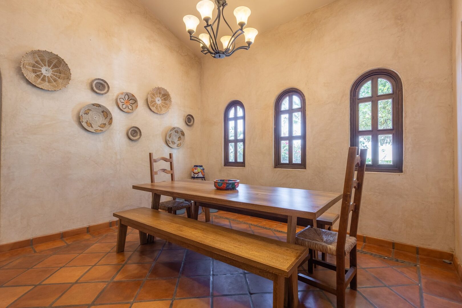 Dining room with handwoven wall baskets and arched windows