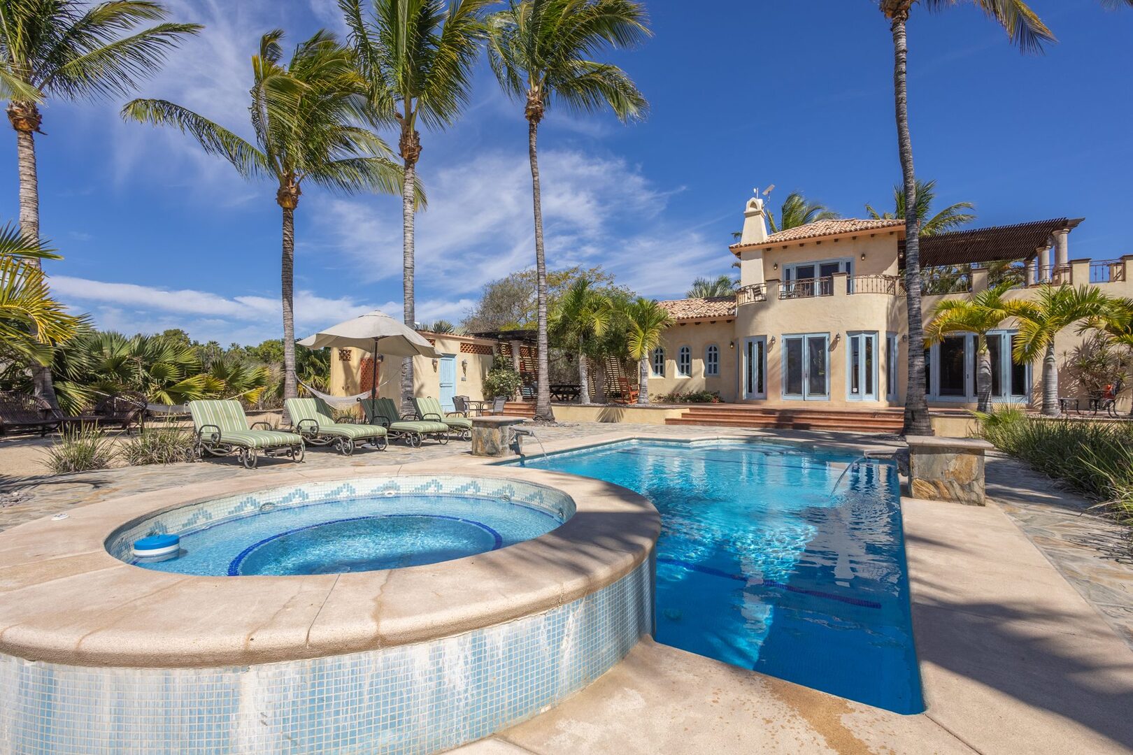 Pool and hot tub with main house in the background