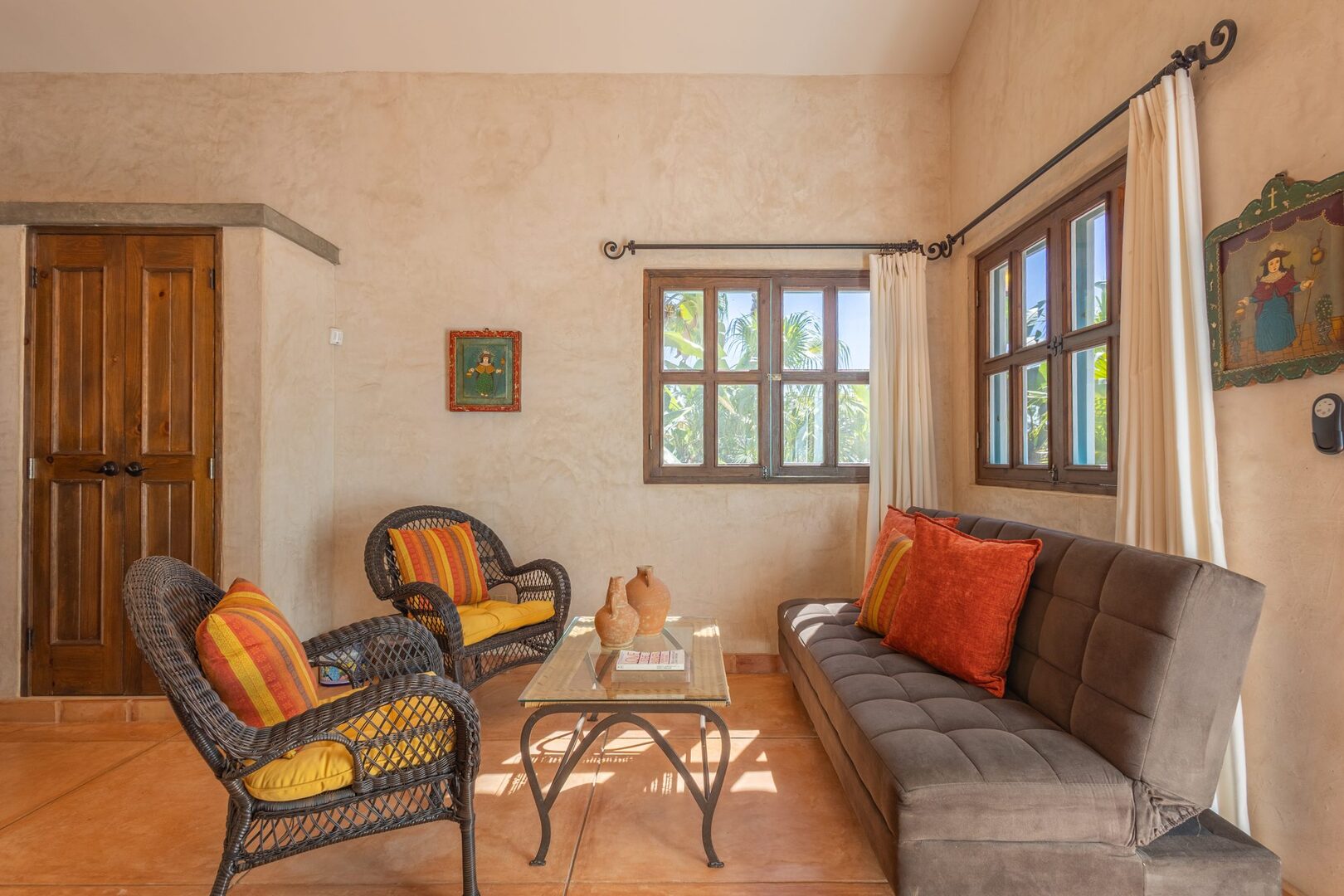 Sitting area with wicker chairs and folk art