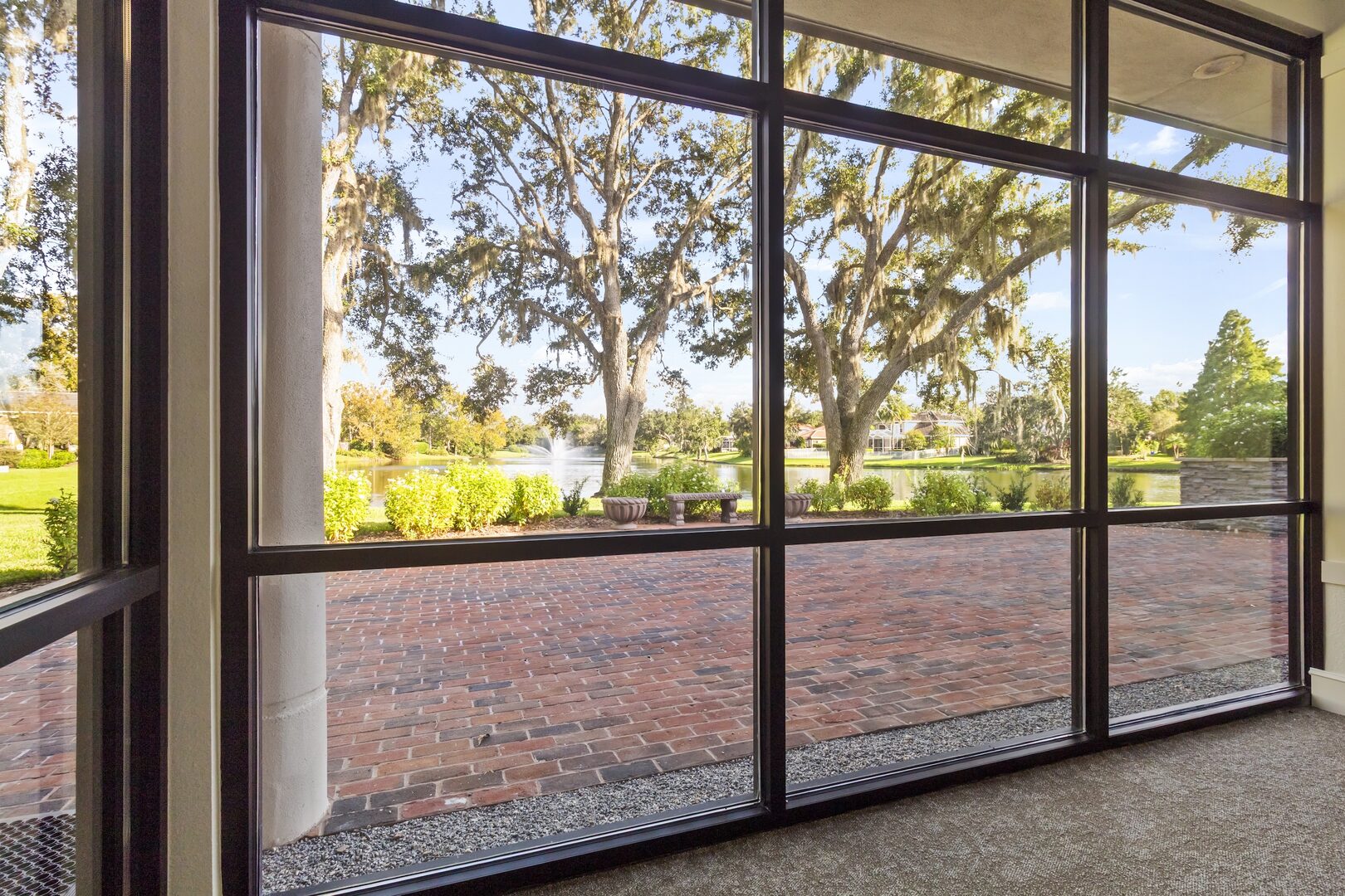 Screened porch view of the brick patio and lake