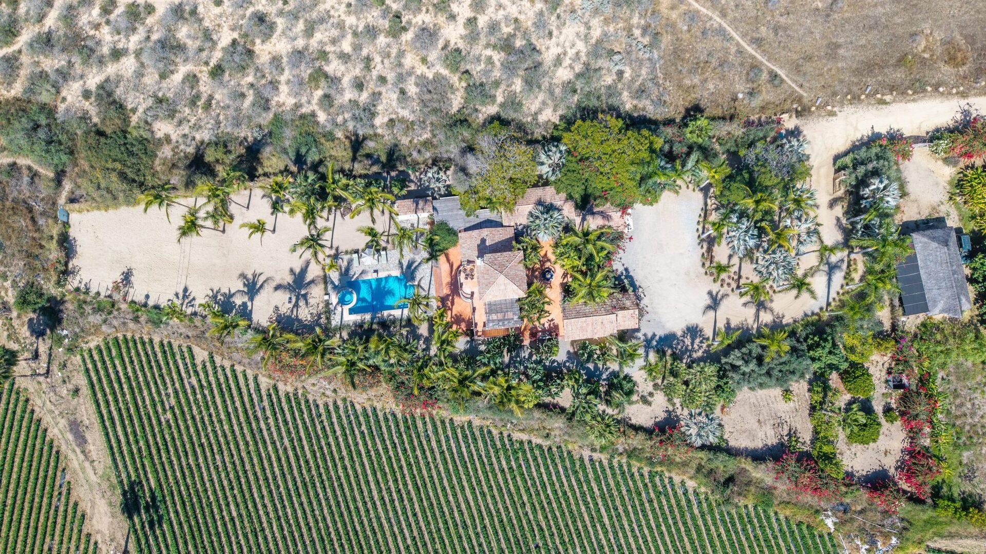 Overhead aerial of the full compound with pool and casitas